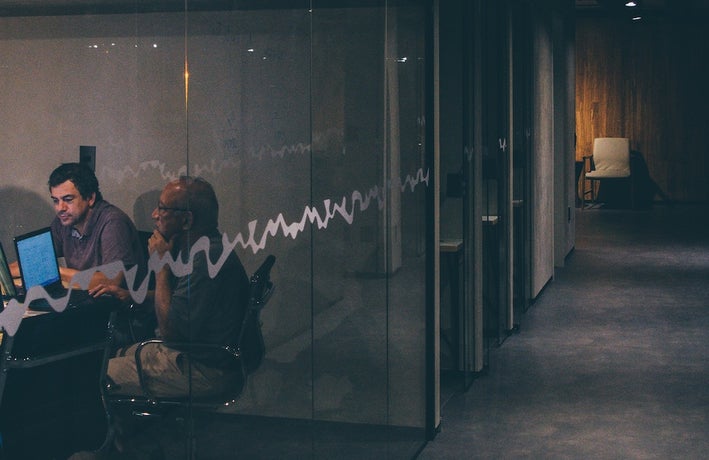 two men working in a dark office